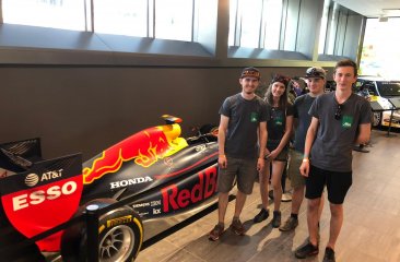 Alba trainees in front of an original Formula 1 car.
